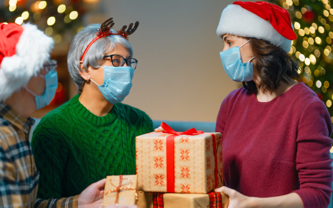 A family celebrating Christmas while wearing masks during COVID-19