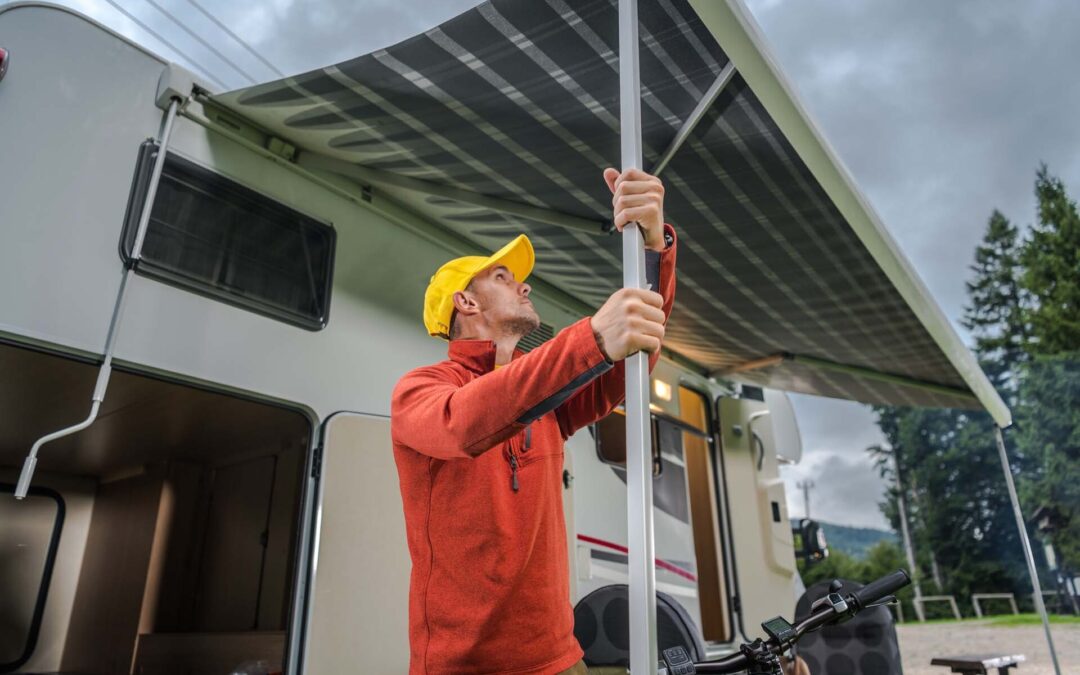 RV owner setting up their canopy to prevent water damage